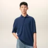 Ami de Coeur Polo de algodón azul con parche bordado Ami de Coeur Polo de algodón azul con parche bordado