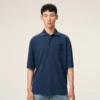 Ami de Coeur Polo de algodón azul con parche bordado Ami de Coeur Polo de algodón azul con parche bordado