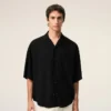 Camisa negra de manga corta con bordado «Ami Paris» y corte holgado