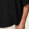 Camisa negra de manga corta con bordado «Ami Paris» y corte holgado