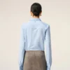 Camisas ajustadas de manga larga con volantes de algodón azul Camisas ajustadas de manga larga con volantes de algodón azul