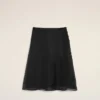 Falda trapecio midi de seda negra con enagua transparente Falda trapecio midi de seda negra con enagua transparente