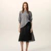 Falda trapecio midi de seda negra con enagua transparente Falda trapecio midi de seda negra con enagua transparente