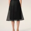 Falda trapecio midi de seda negra con enagua transparente Falda trapecio midi de seda negra con enagua transparente