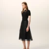 Falda trapecio midi de seda negra con enagua transparente Falda trapecio midi de seda negra con enagua transparente