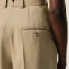 Pantalones beige de lana virgen con cintura alta y pierna ancha Pantalones beige de lana virgen con cintura alta y pierna ancha