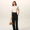 Pantalones negros de lana nueva con cinturón cruzado