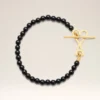 Pulsera Ami De Cœur de latón negro con perlas de verano doradas